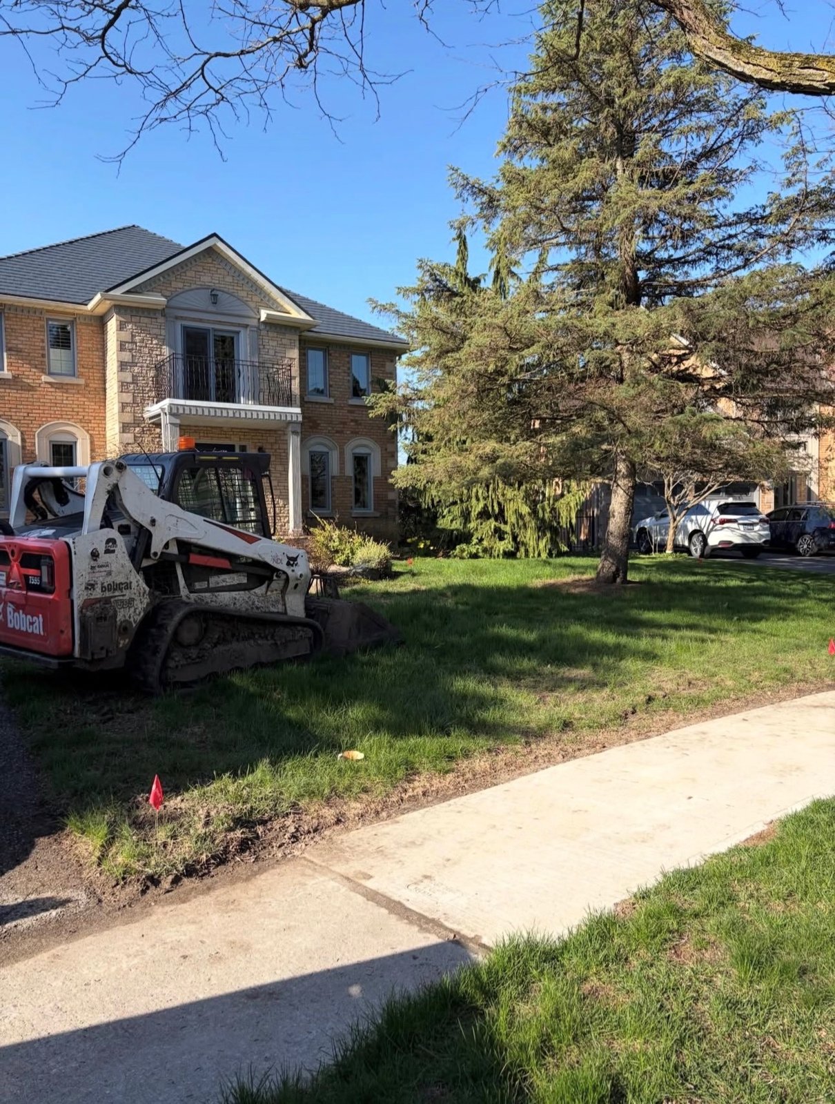 Landscaping prep with skidsteer on a GTA property by OSS Lawn Care
